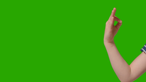 Close-Up-Of-Young-Girl-Making-Meditation-Mudra-Gesture-To-Camera-Against-Green-Screen